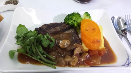 The main course, which was steak with either pancetta and tomato sauce or daikon radish soy sauce. I had the tomato sauce. The steak tasted fine, but reminded me of something I'd have in economy.