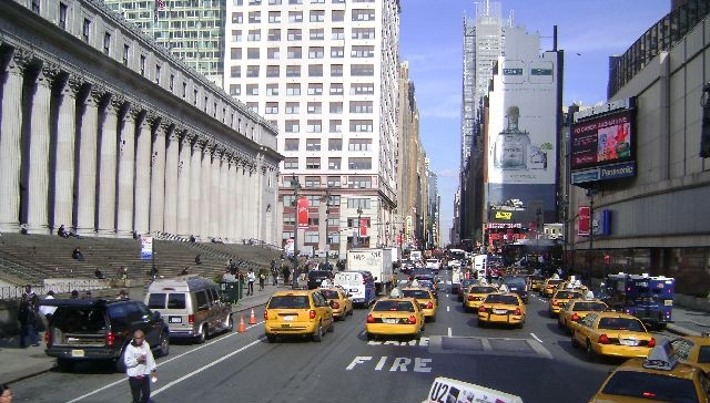 a busy city street with cars and people