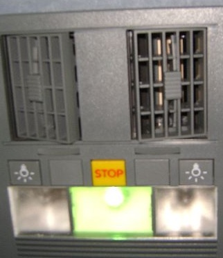 close-up of a grey machine with a green light