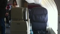 a group of people standing in an airplane