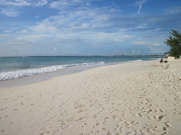 a sandy beach with footprints in the sand