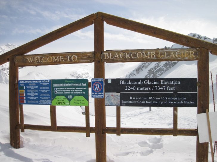 a sign on a wooden post