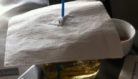 a glass with liquid and a straw on top