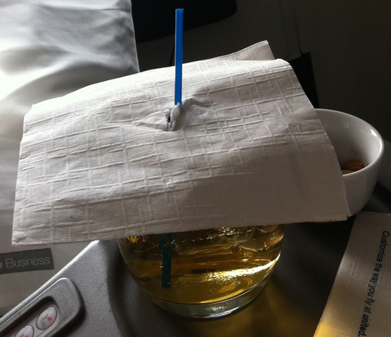 a glass with liquid and a straw on top