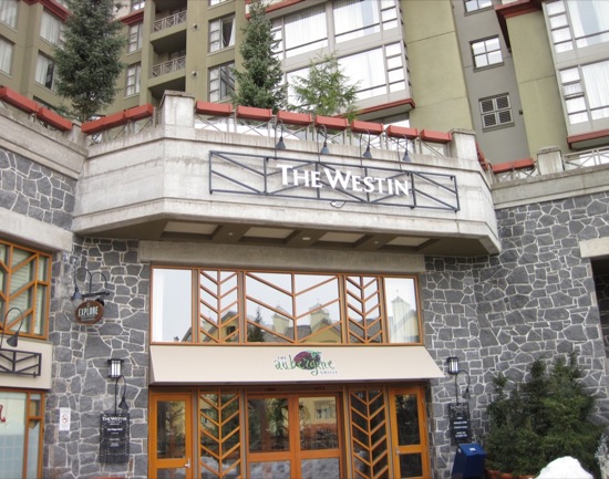 a building with a stone wall and a stone balcony