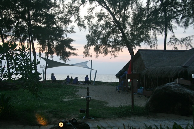 a group of people sitting on a beach