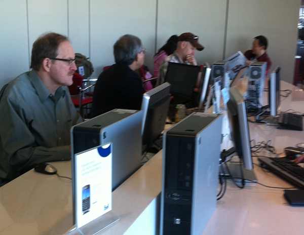 a group of people sitting at computers