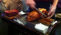 a person cutting a whole turkey