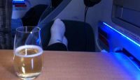 a glass of beer and a person's leg