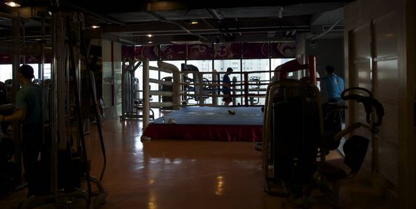 a gym with a large bed and exercise equipment