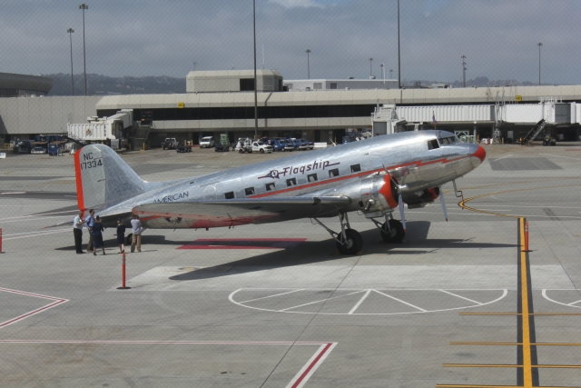 a silver airplane on the tarmac