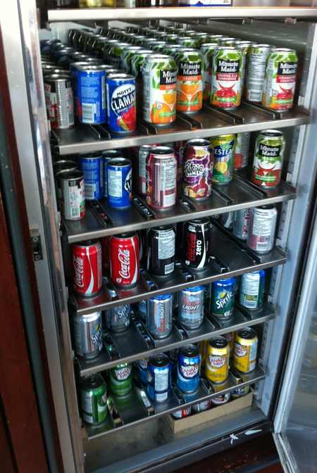 a shelf of cans of soda