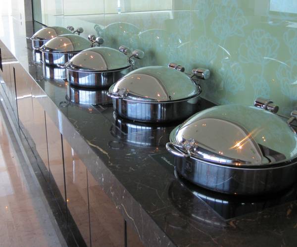 a row of stainless steel pots