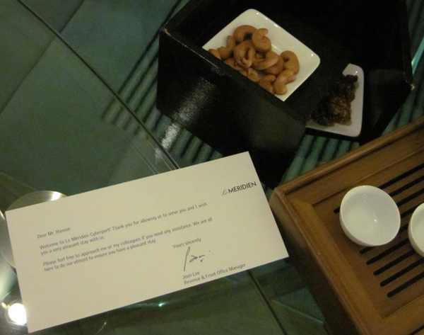 a close-up of a paper and a bowl of cashews