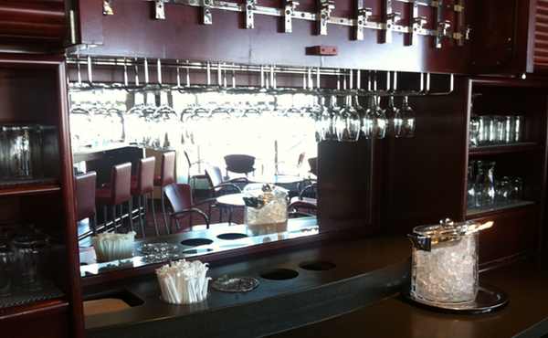 a bar with wine glasses from a bar