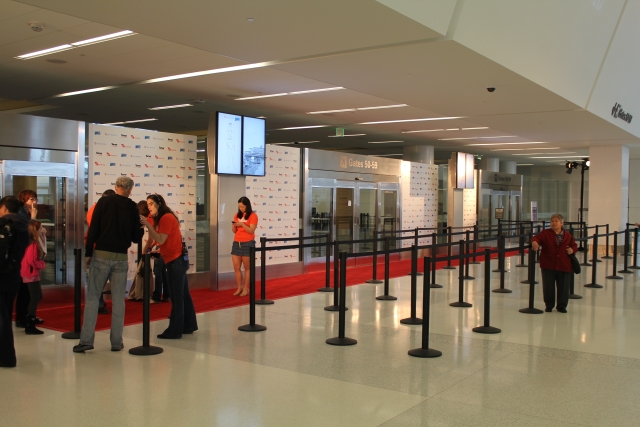people standing in a line at an airport