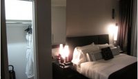 a bedroom with a bed and a closet