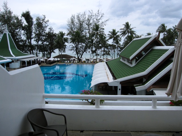 a pool with a green roof and a white railing