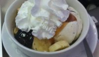a bowl of ice cream with whipped cream on top