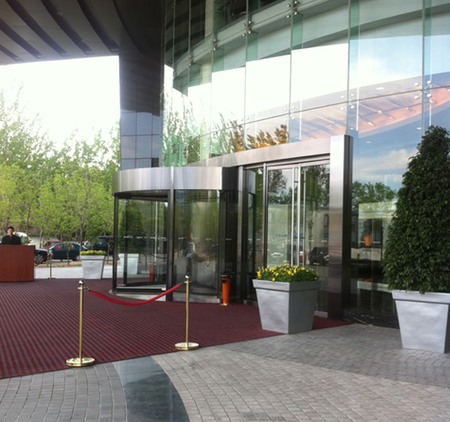 a glass building with a red carpet