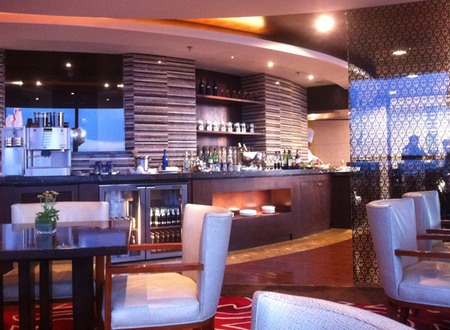 a room with a bar and chairs