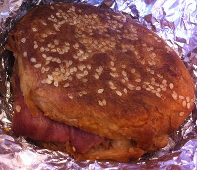 a sandwich with sesame seeds on it