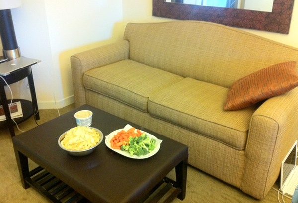 a couch with a bowl of food on it