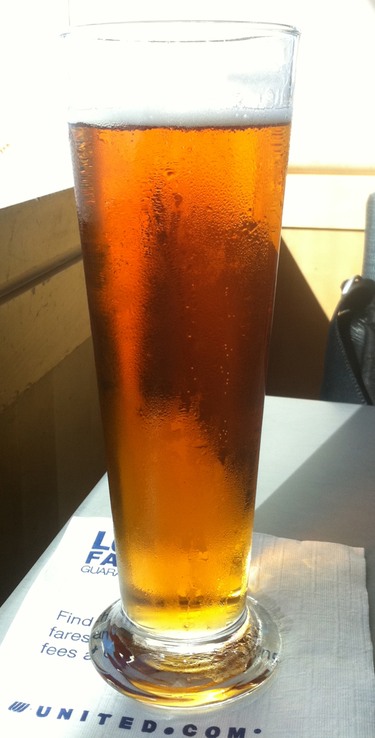 a glass of beer on a napkin