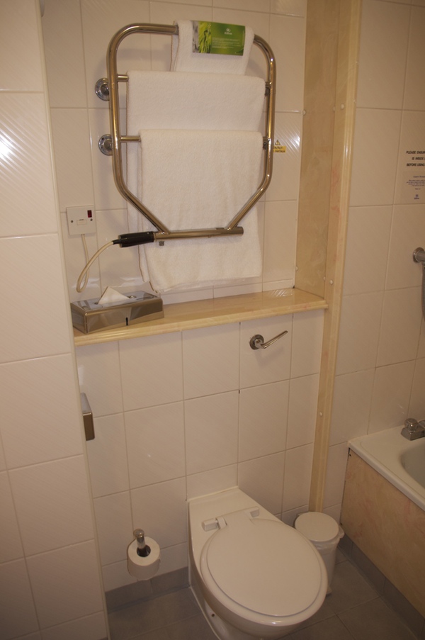 a towel rack and toilet in a bathroom