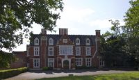 a large brick building with trees