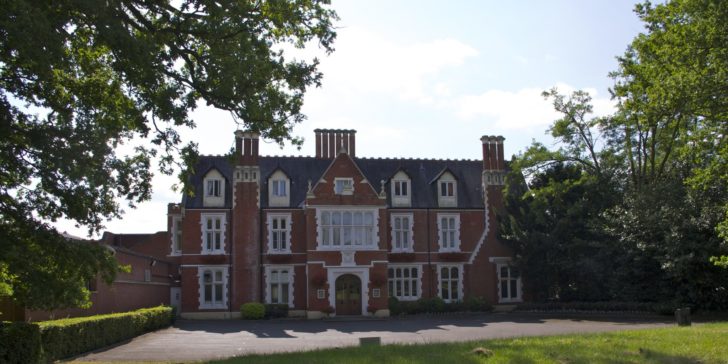 a large brick building with trees
