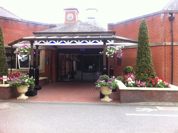 a building with a door and a flower bed