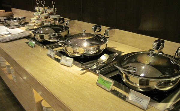a row of silver pans on a counter