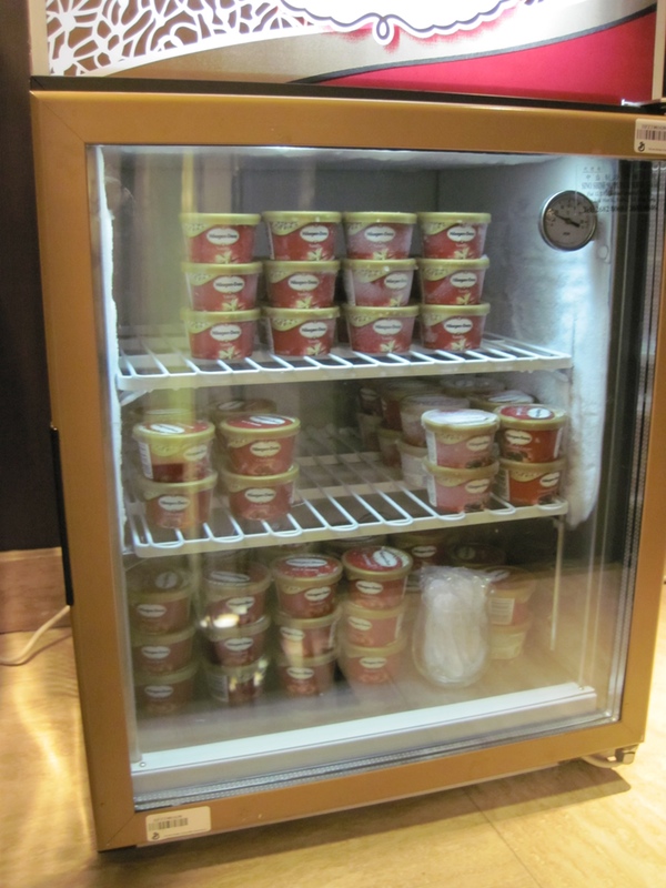 a refrigerator with food containers on shelves