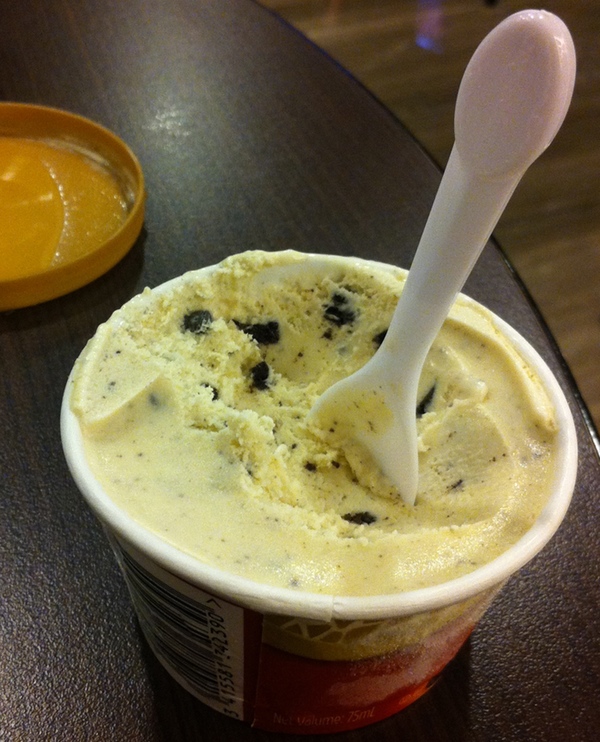 a spoon in a cup of ice cream