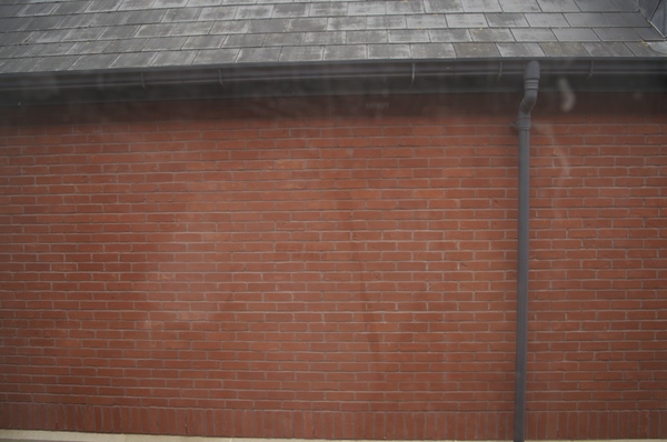 a brick wall with a gutter