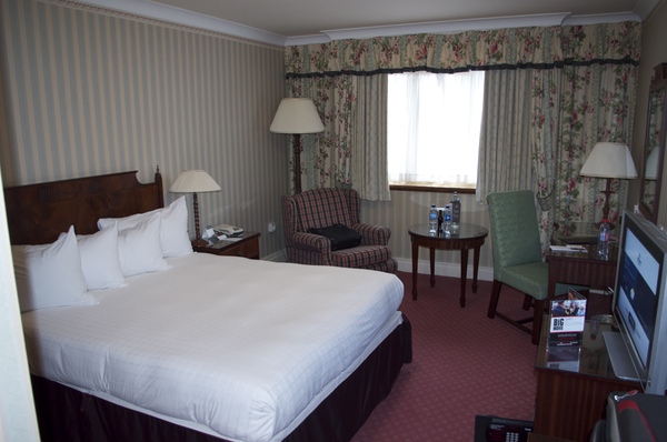 a hotel room with a bed and chairs