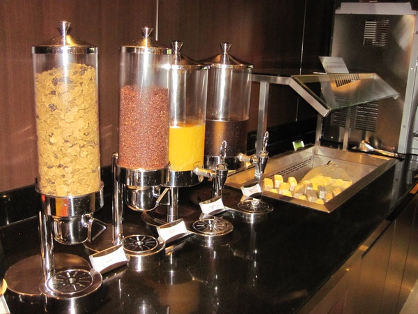 a breakfast buffet with cereals and juice
