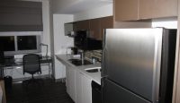 a kitchen with a stainless steel refrigerator