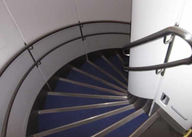 a spiral staircase with blue carpet