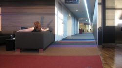 a woman sitting on a couch in a hallway