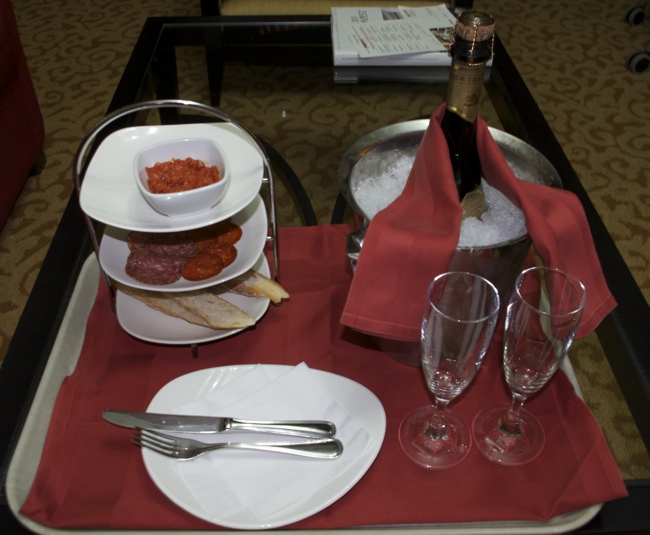 a tray with food and wine on it