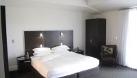 a bedroom with a bed and a chair