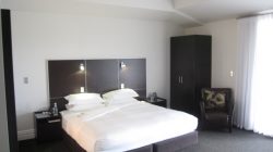 a bedroom with a bed and a chair