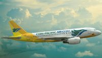 a yellow and white airplane flying in the sky
