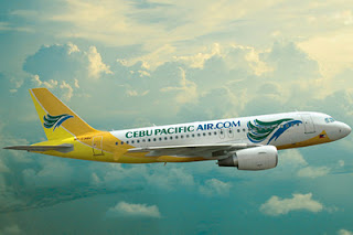 a yellow and white airplane flying in the sky