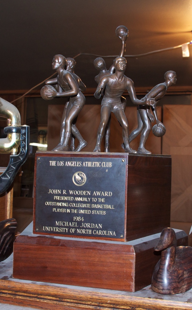 a trophy with a group of people playing basketball