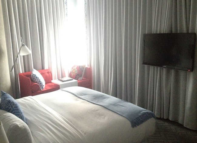 a bed in a room with curtains