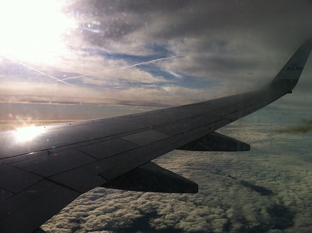 the wing of an airplane flying above clouds
