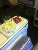 a glass of liquid and a packet on a table